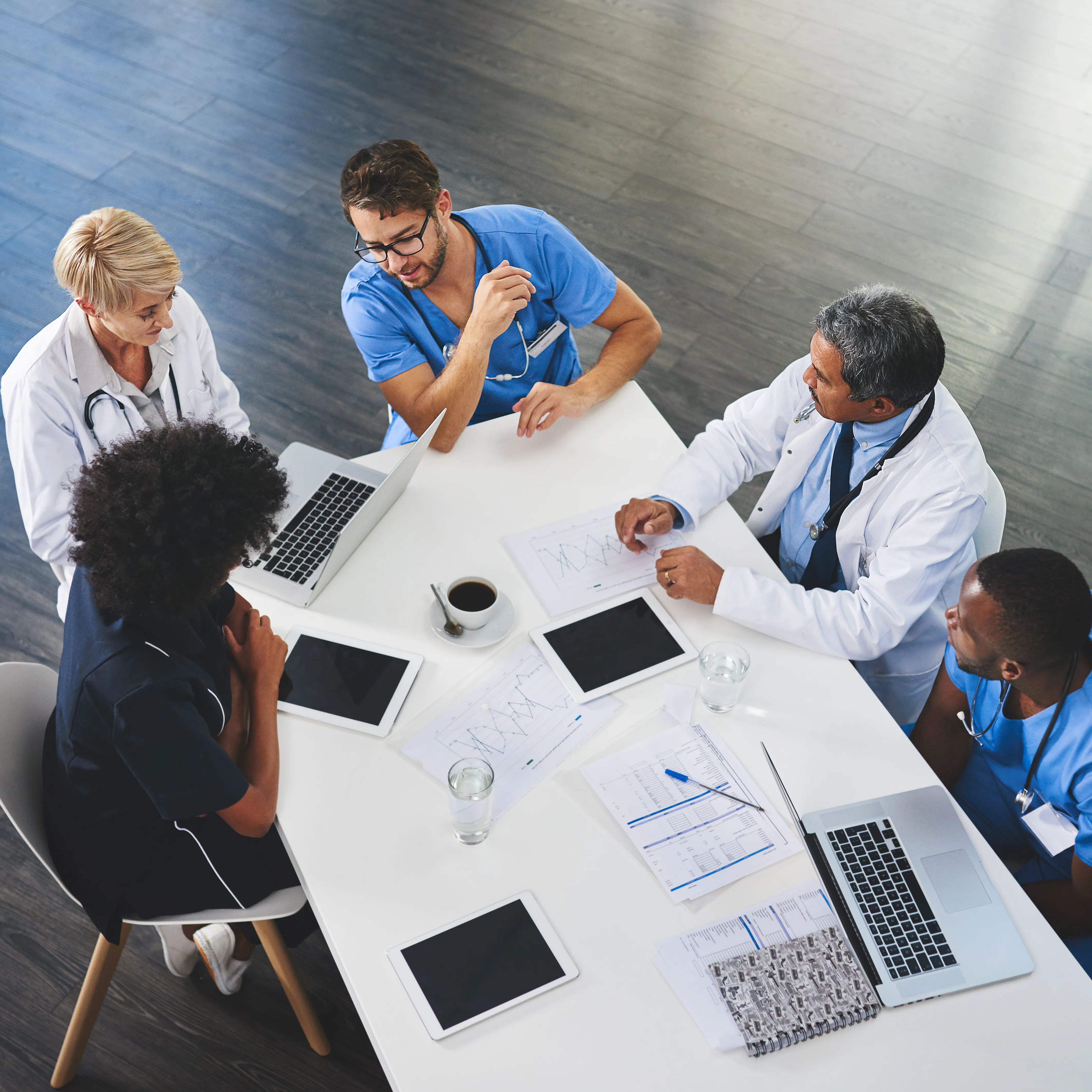 Healthcare providers in discussion around a conference table